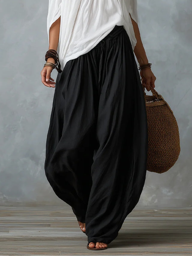 Julianna - Top bianco con spalle scoperte e pantaloni larghi a lanterna